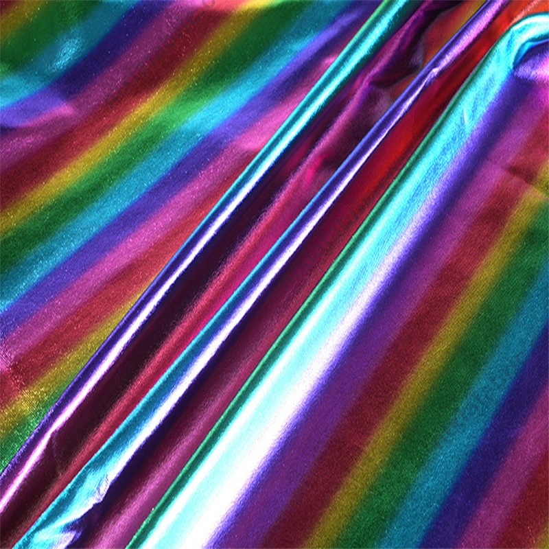 Close-up of metallic rainbow stripe foil 4-way stretch fabric surface