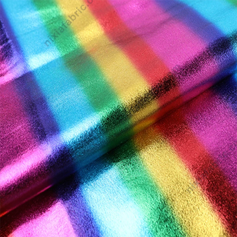 Rainbow stripe reflective foil stretch fabric close-up for dancewear and carnival costumes