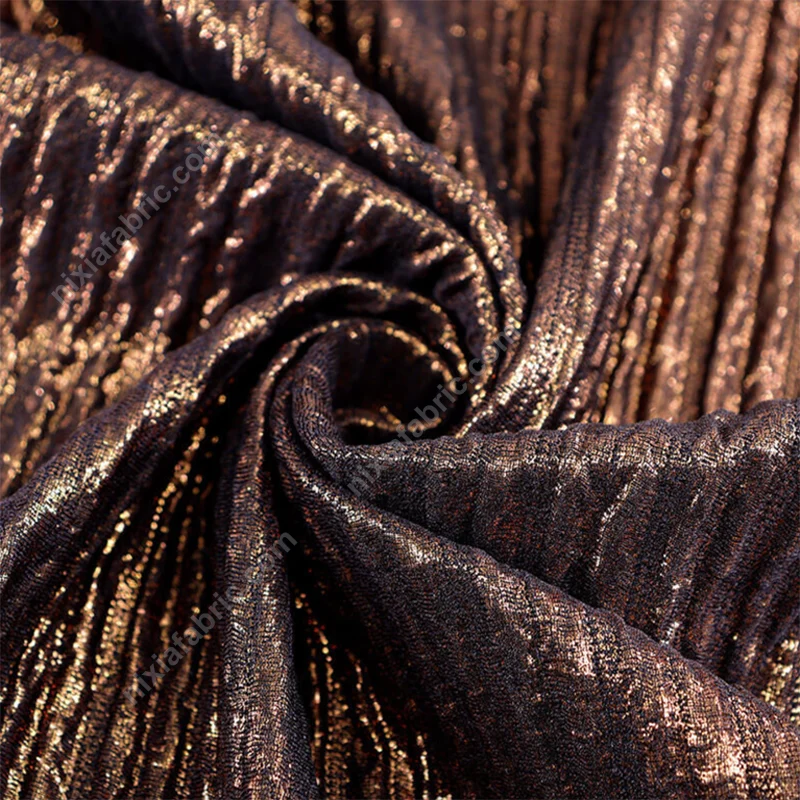 Pleated foil fabric close-up showing dimensional vertical lines
