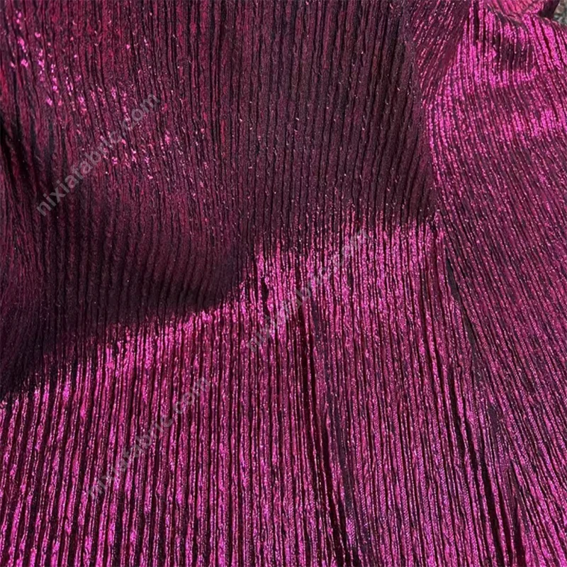 Reflective vertical pleats on foil knit fabric for stagewear buyers