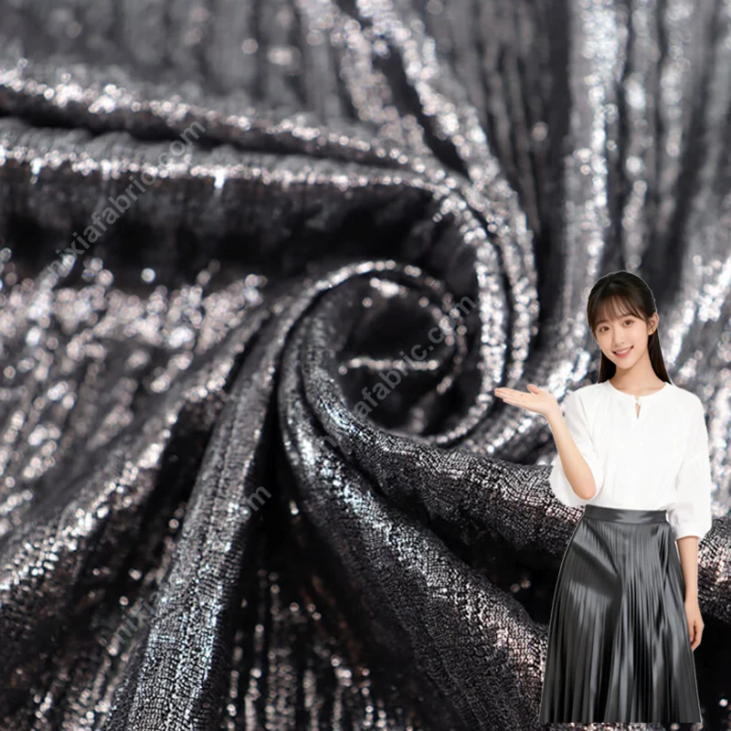 Pleated foil knit fabric surface with vertical metallic texture