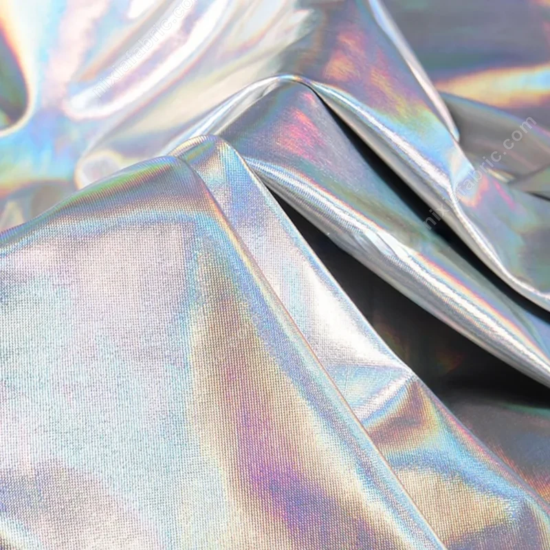 Reflective laser foil surface on stretch spandex fabric for fitted apparel