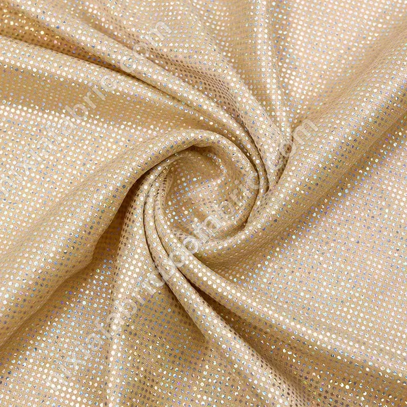 Reflective rainbow dot foil fabric close-up for decorative garment panels