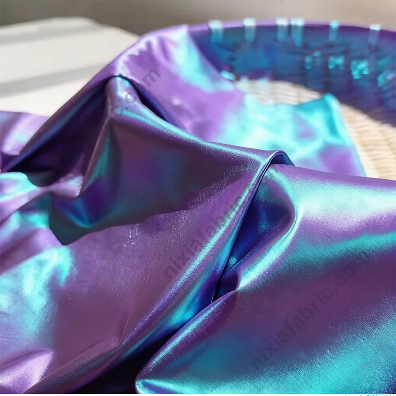 Reflective blue-purple gradient laser foil surface on spandex fabric base