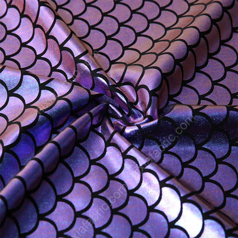 Close-up detail of holographic mermaid scale foil pattern on milk silk stretch fabric